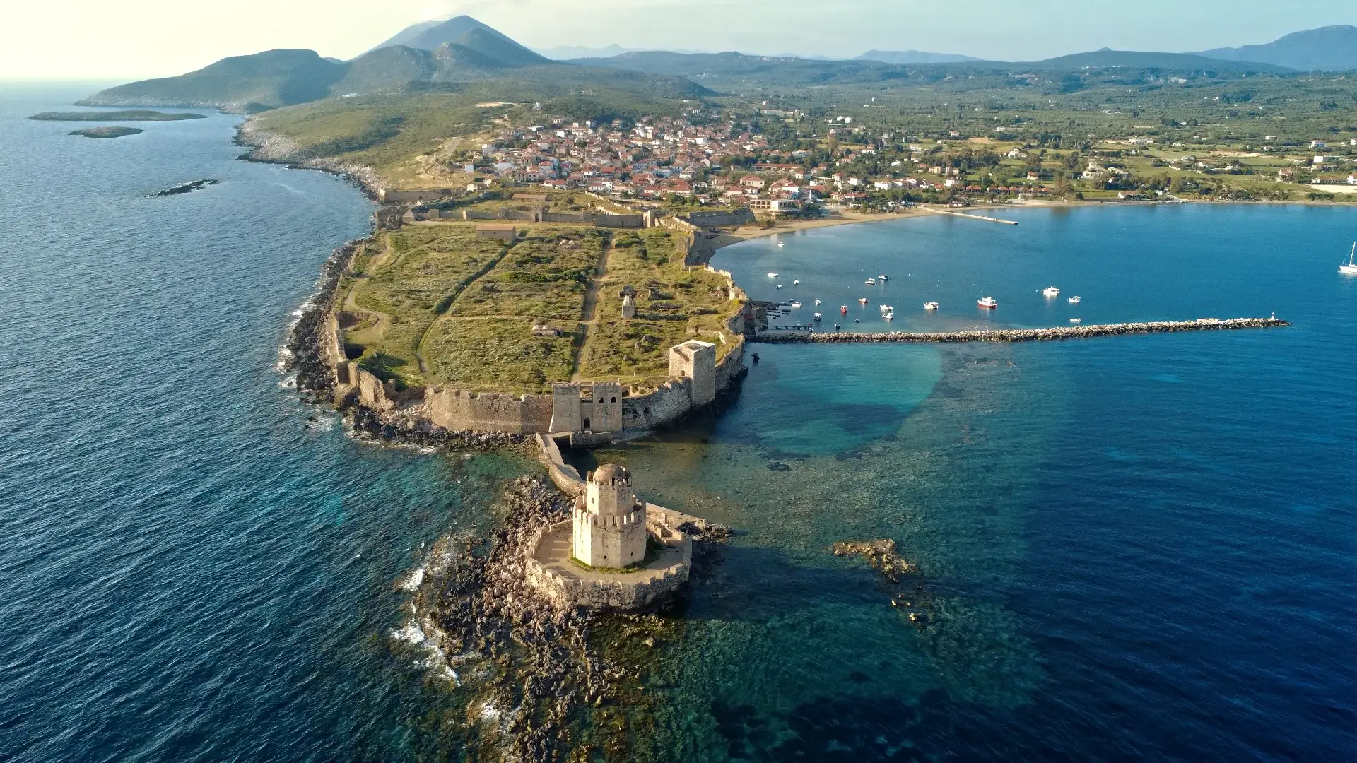 Venetian fortress of Methoni extending into turquoise Mediterranean waters with Bourtzi tower